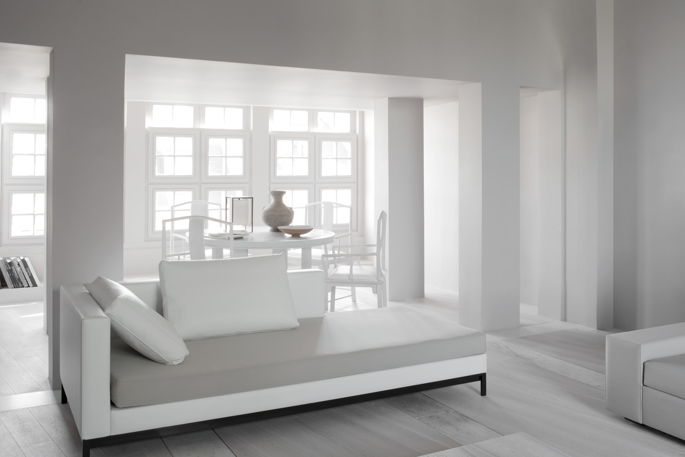 Kennedy Residence by Guillaume Alan — living room, low sofa in front of the tall multi-pane windows, residence in Paris