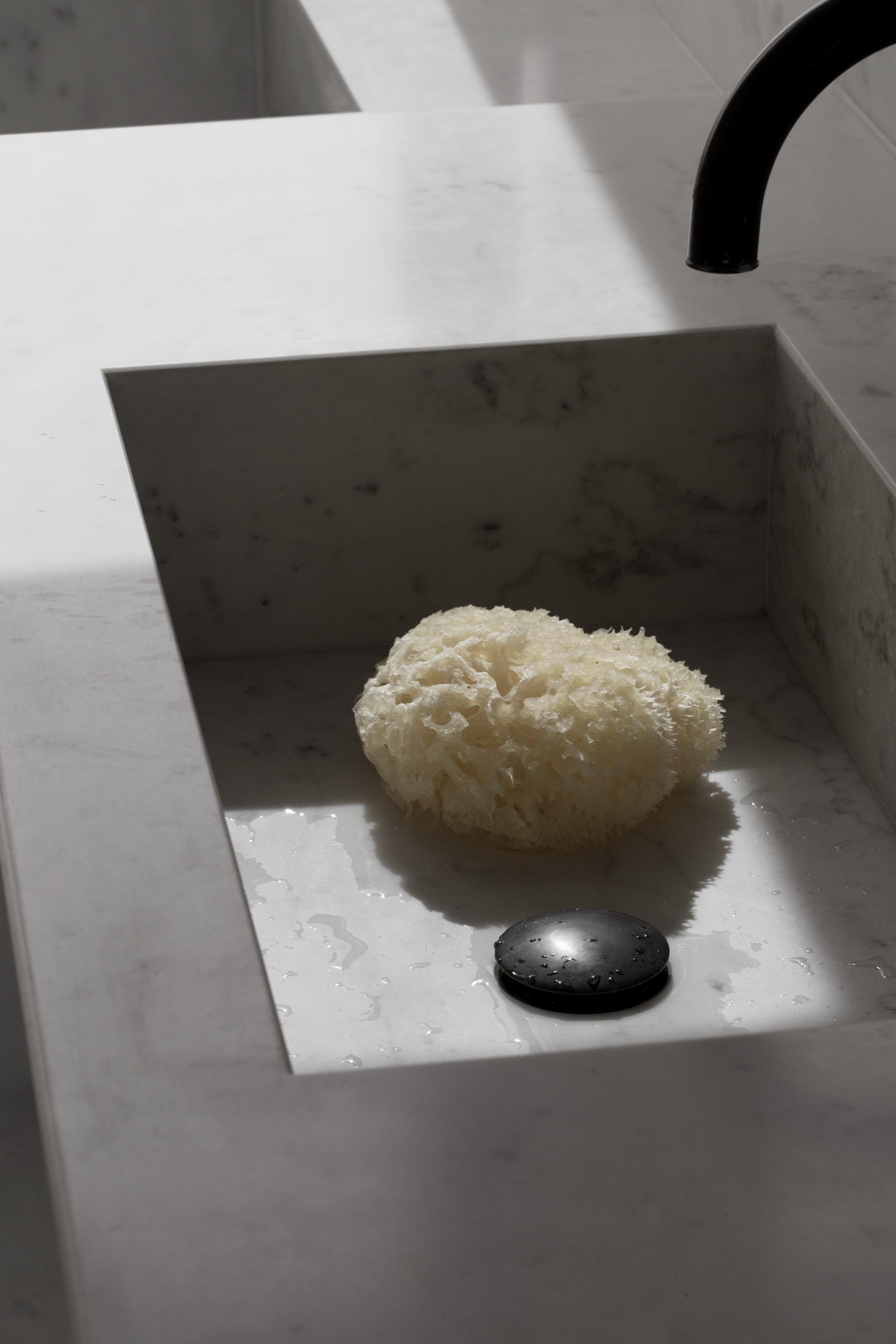 Kennedy Residence by Guillaume Alan — bathroom, dark basin and black tap on a marble counter, residence in Paris