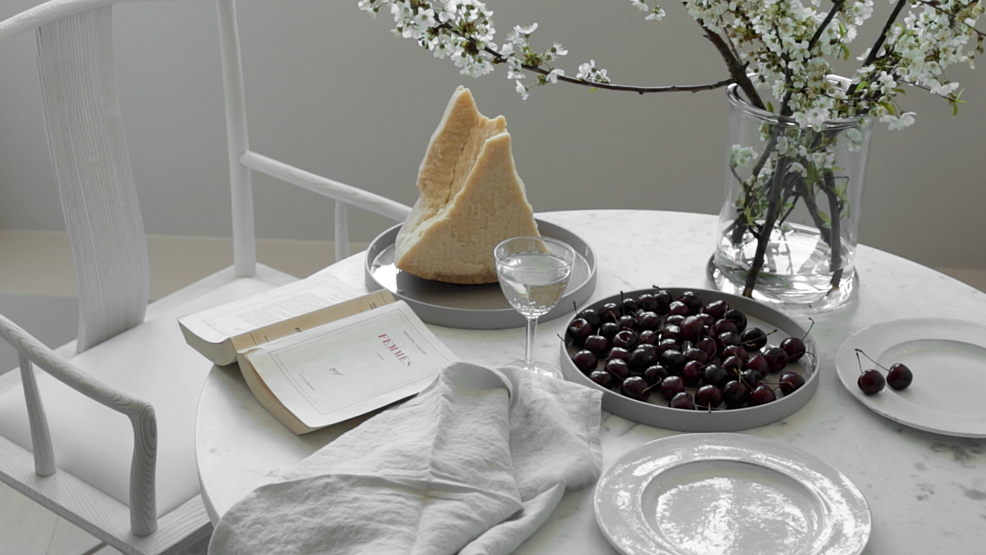 Kennedy Residence by Guillaume Alan — still life, bread, cherries and open book on a round marble table, residence in Paris