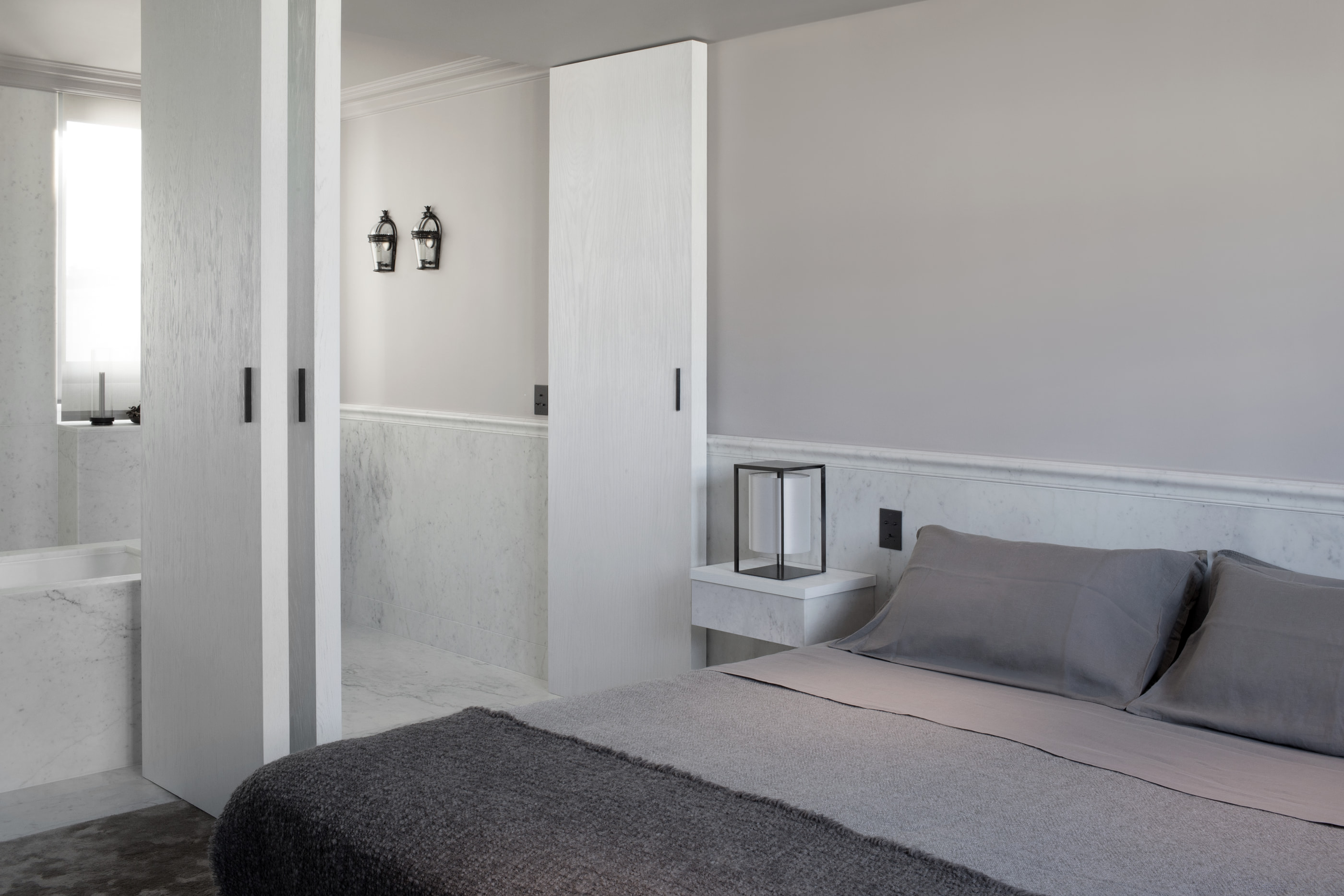 Kennedy Residence by Guillaume Alan — bedroom, grey bed and glazed partition onto the bathroom, residence in Paris