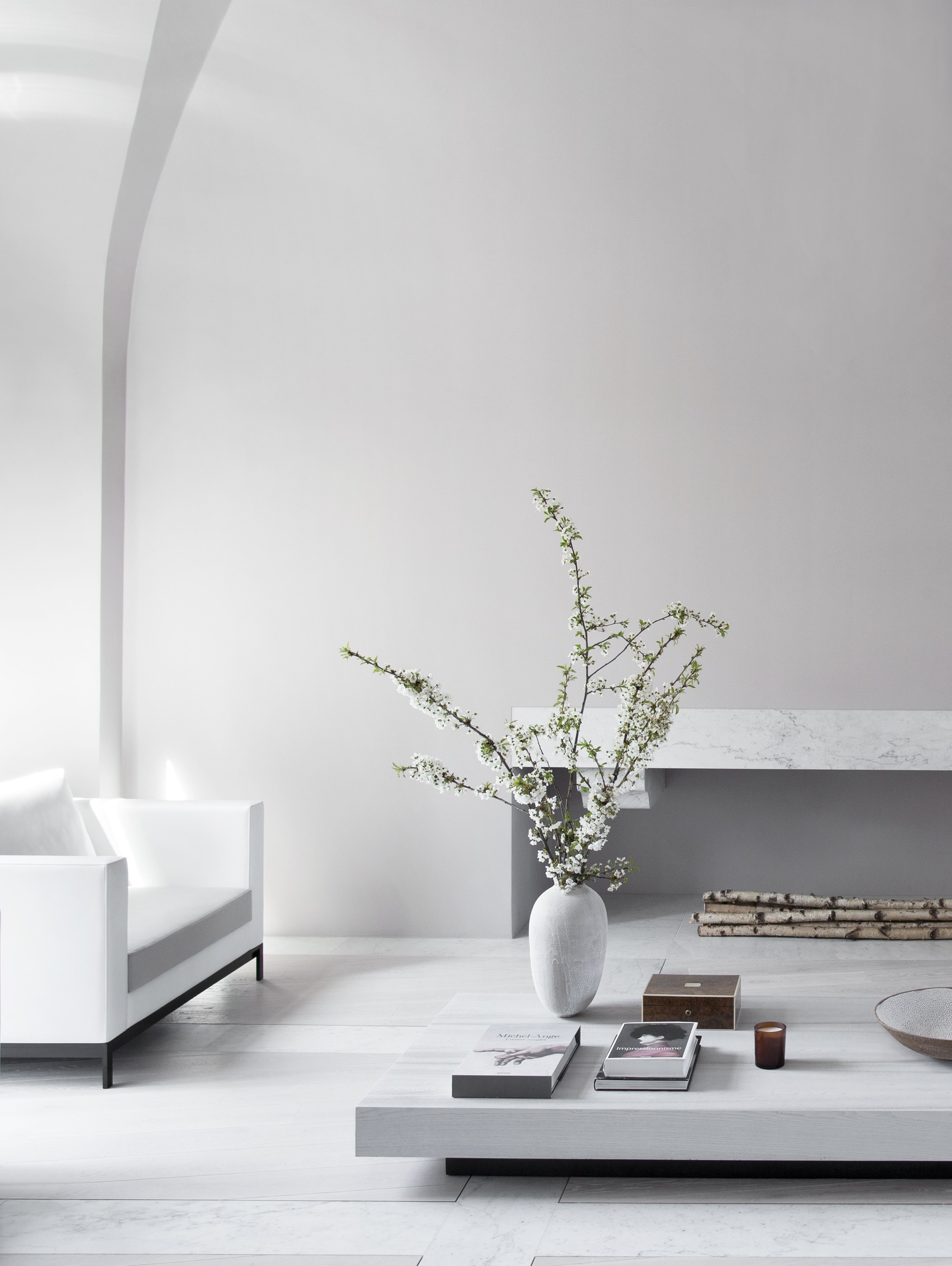 Kennedy Residence by Guillaume Alan — living room, linen armchair and low coffee table in front of a niche, residence in Paris