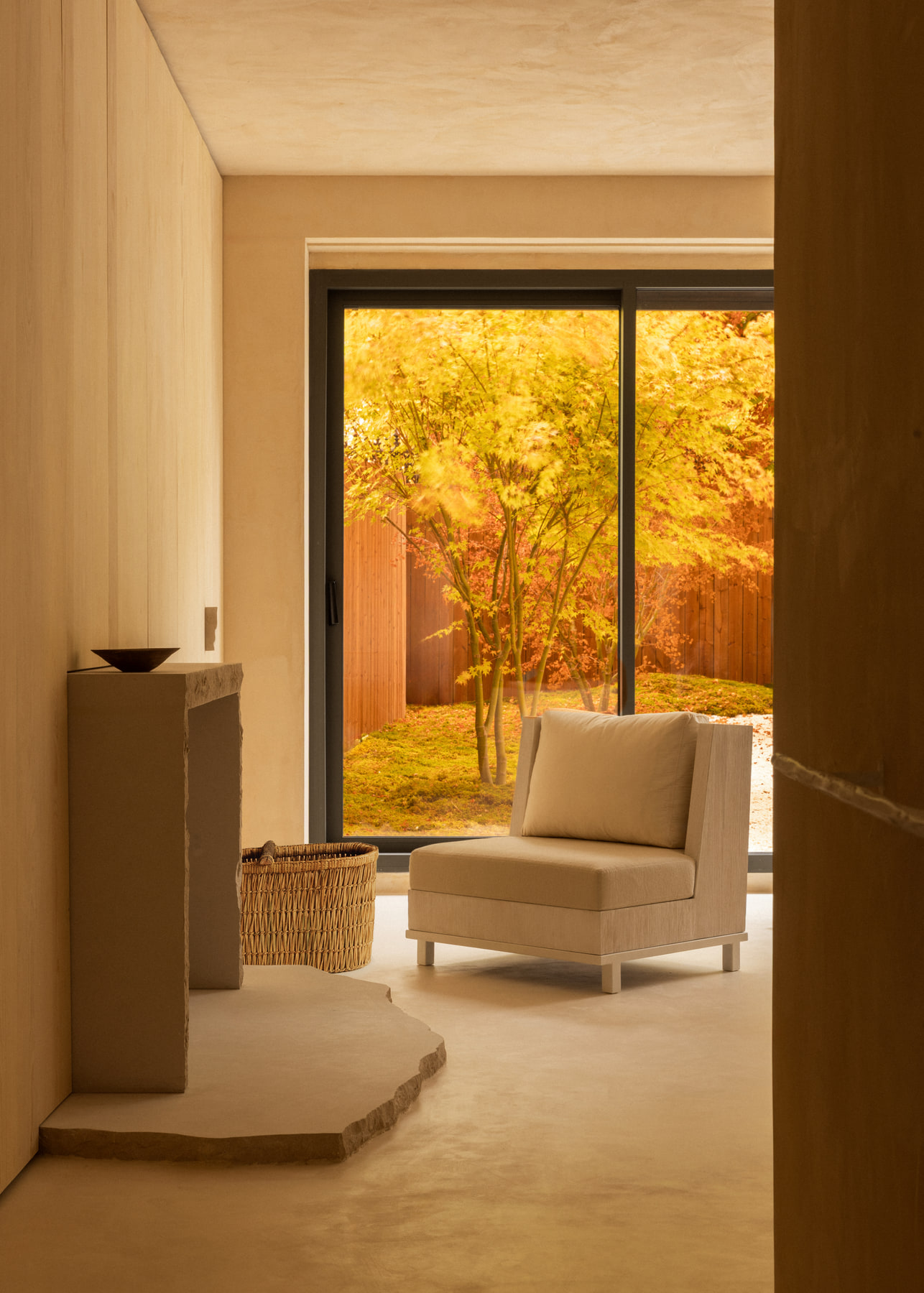 L’Imparfait by Guillaume Alan — armchair by the window onto the autumn garden, apartment in Paris