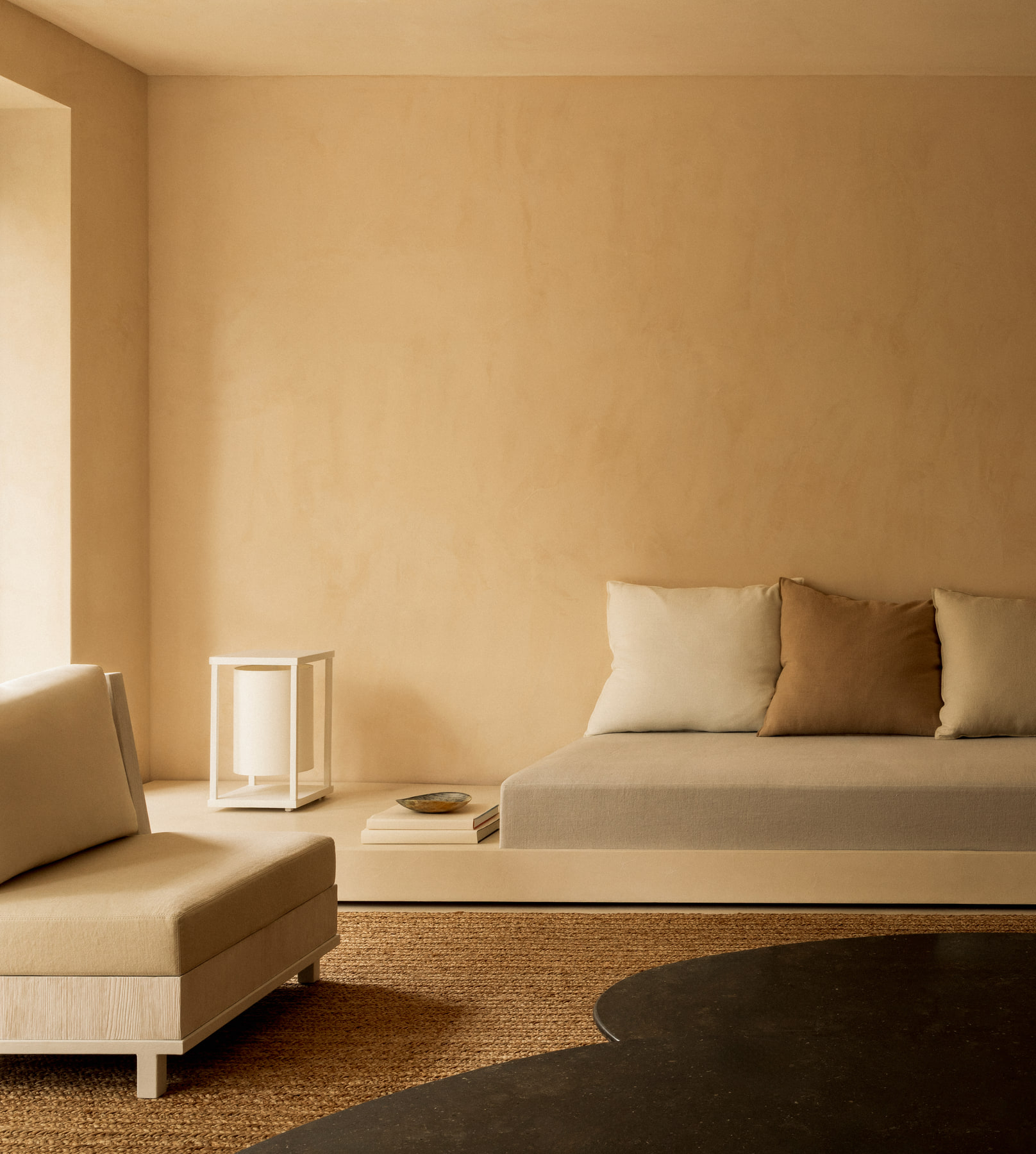 L’Imparfait by Guillaume Alan — living room with low sofa and paper floor lamp, apartment in Paris