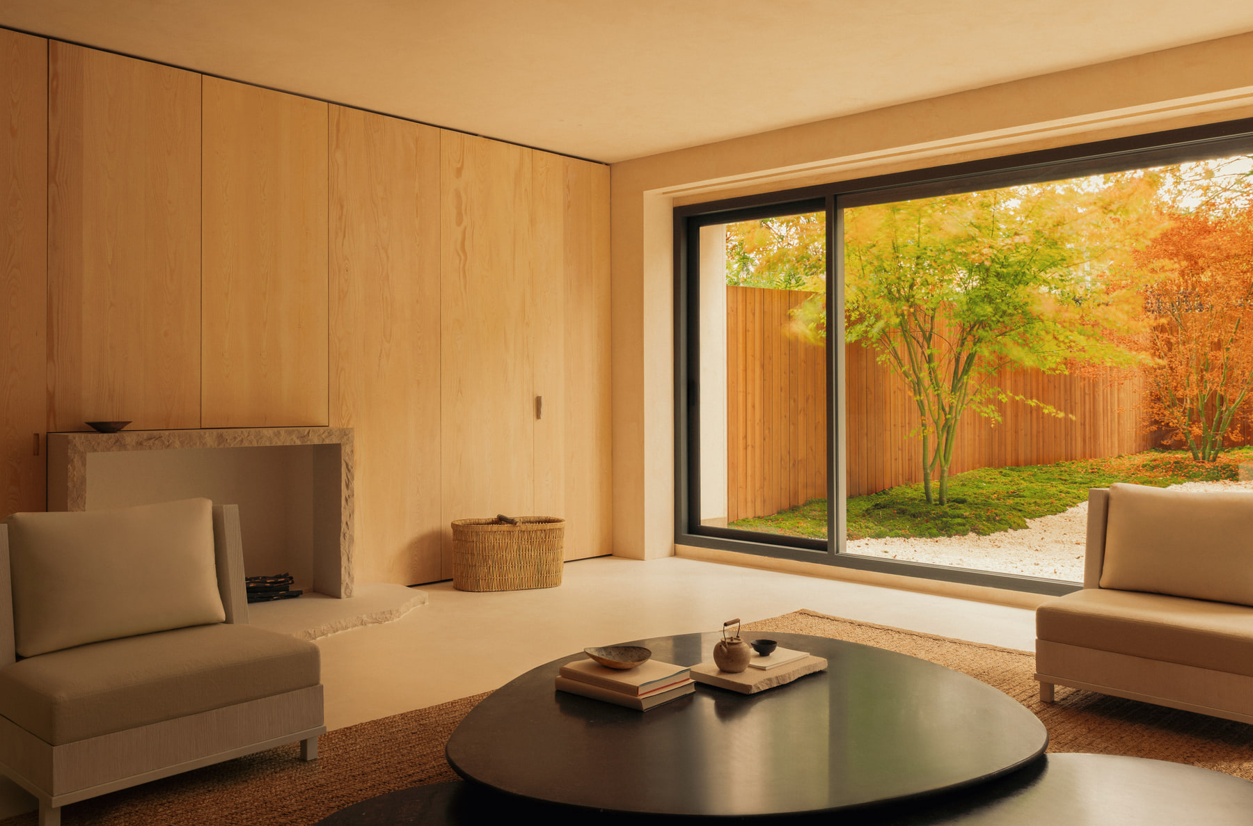 L’Imparfait by Guillaume Alan — living room with round low table and garden view, apartment in Paris