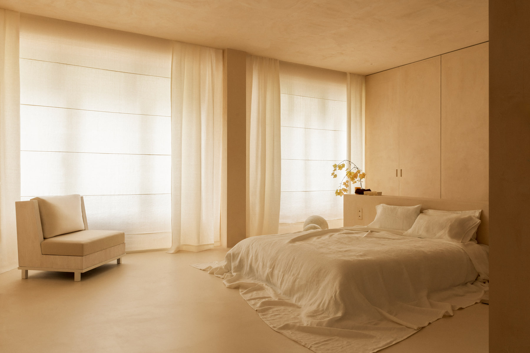 L’Imparfait by Guillaume Alan — bedroom with linen curtains and armchair, apartment in Paris