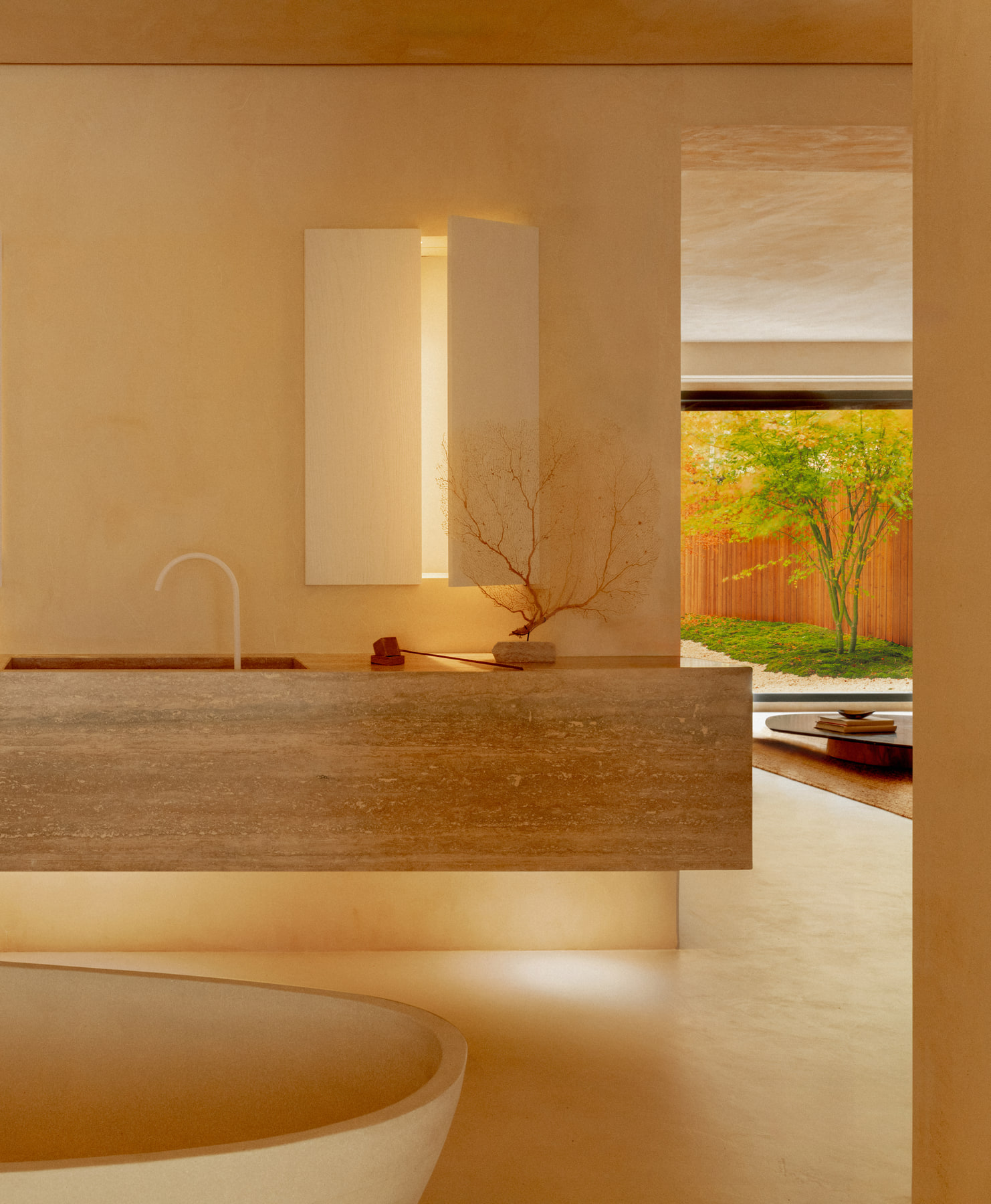 L’Imparfait by Guillaume Alan — bath and travertine vanity facing the garden, apartment in Paris