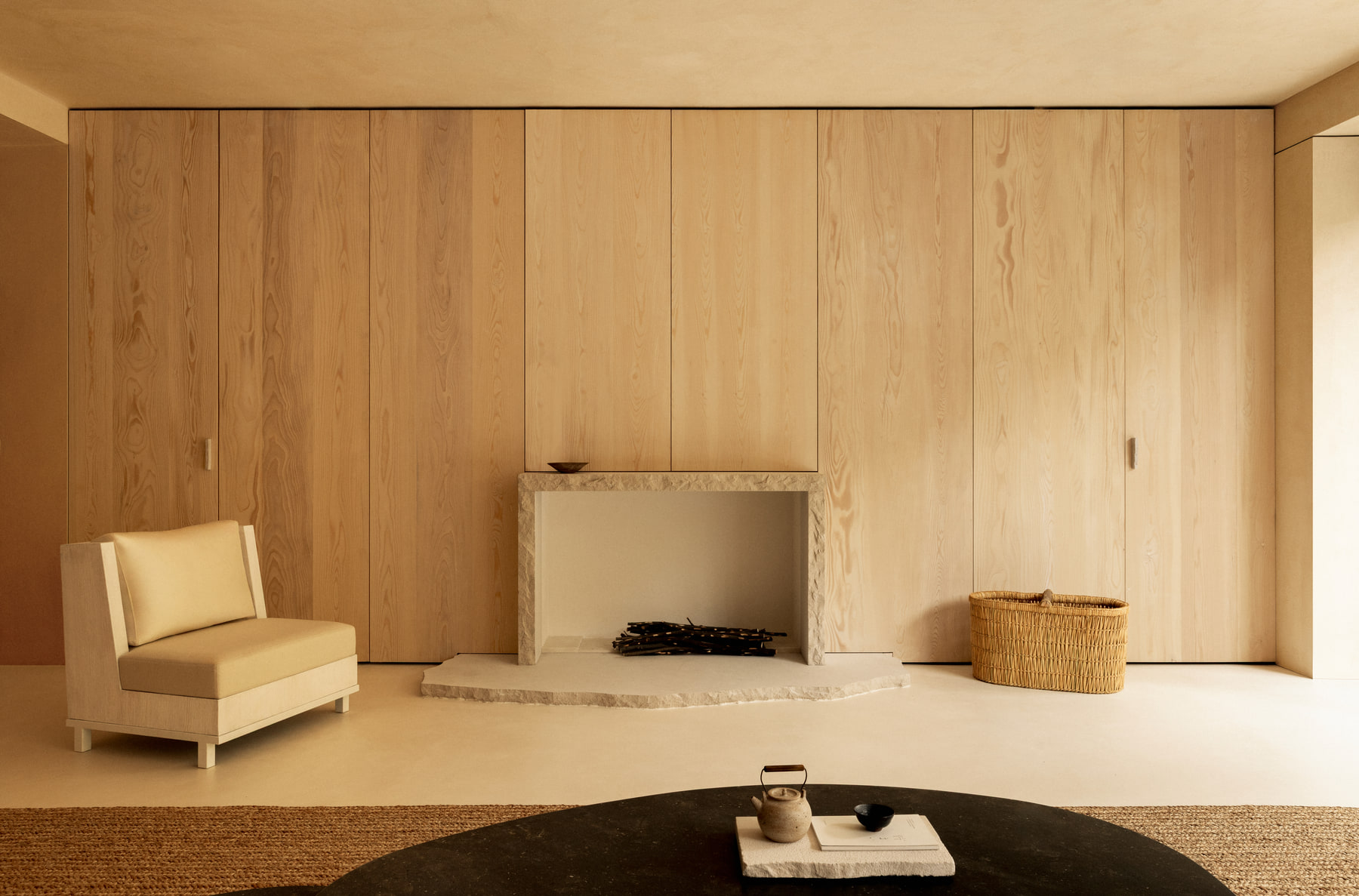 L’Imparfait by Guillaume Alan — sitting room with armchair and plaster walls, apartment in Paris