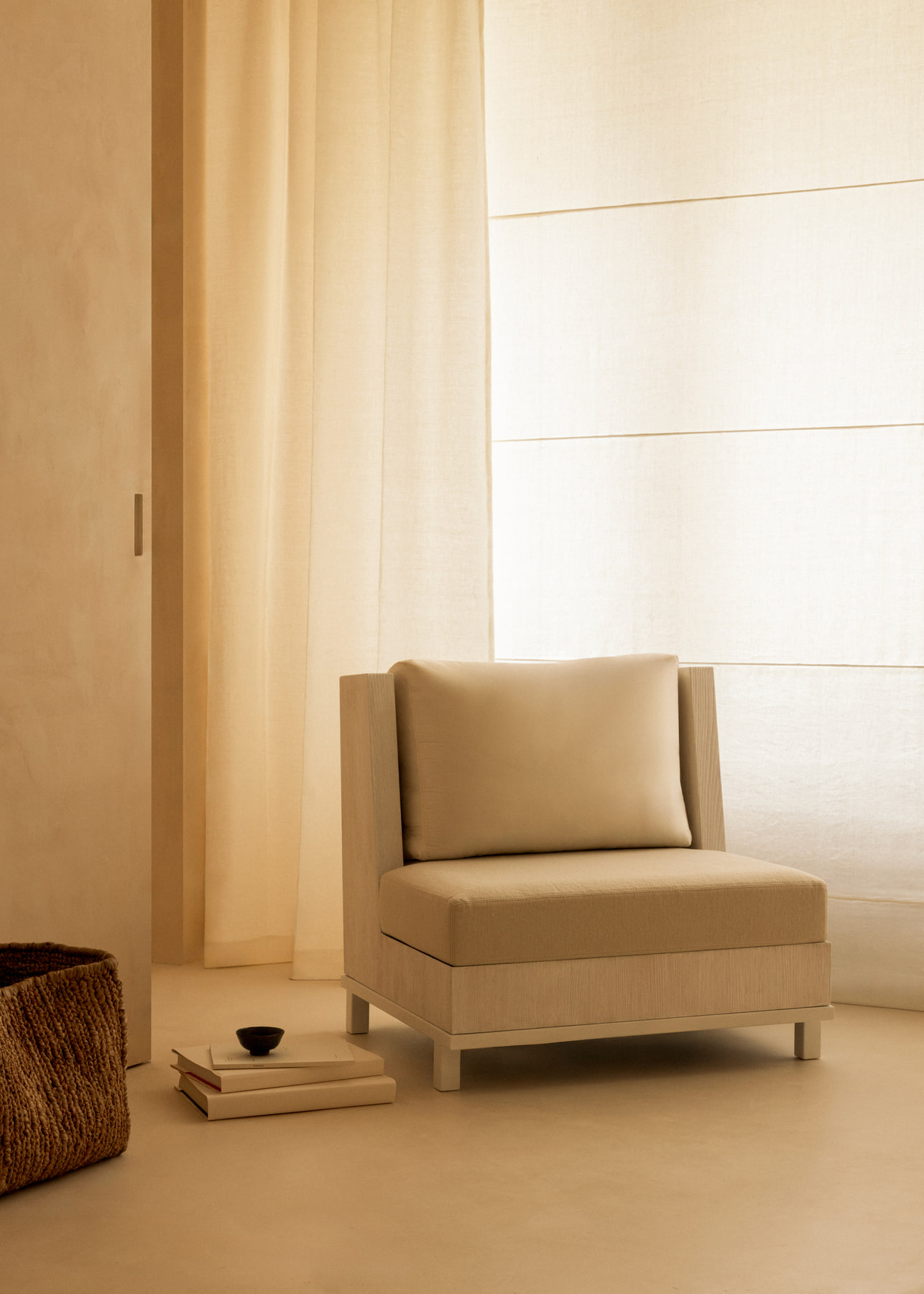 L’Imparfait by Guillaume Alan — armchair and lamp by a linen curtain, apartment in Paris