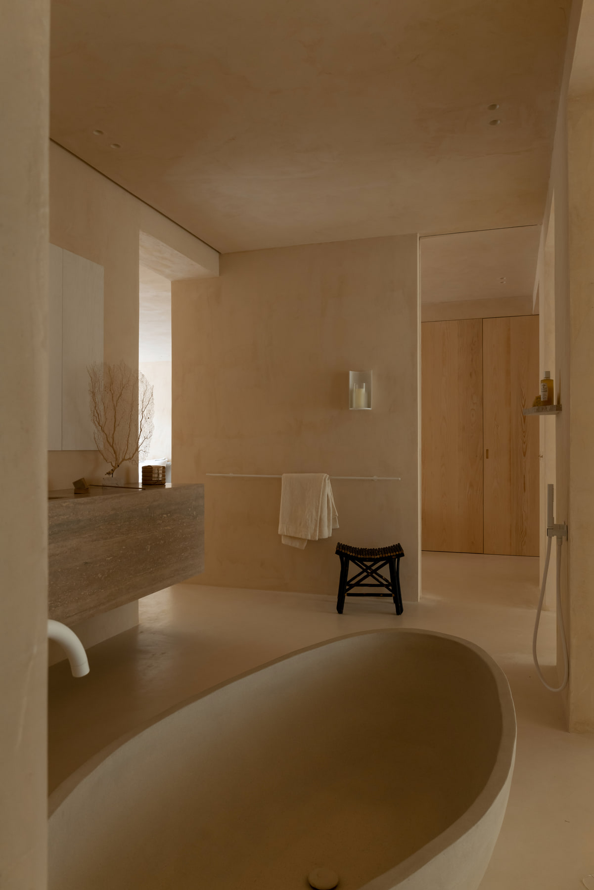 L’Imparfait by Guillaume Alan — bathroom with stone bath and wooden stool, apartment in Paris (photo: Agathe Tissier)