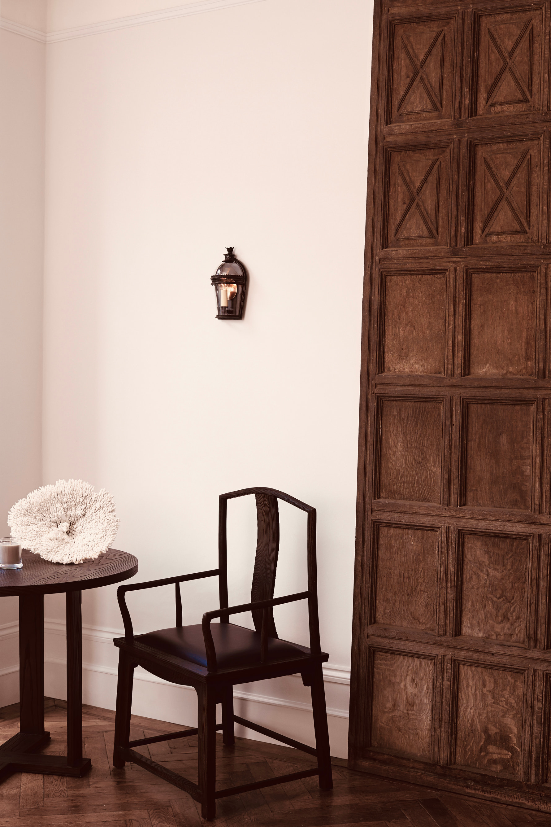 Mayfair House by Guillaume Alan — armchair and sconce in a wood-panelled corner, residence in London