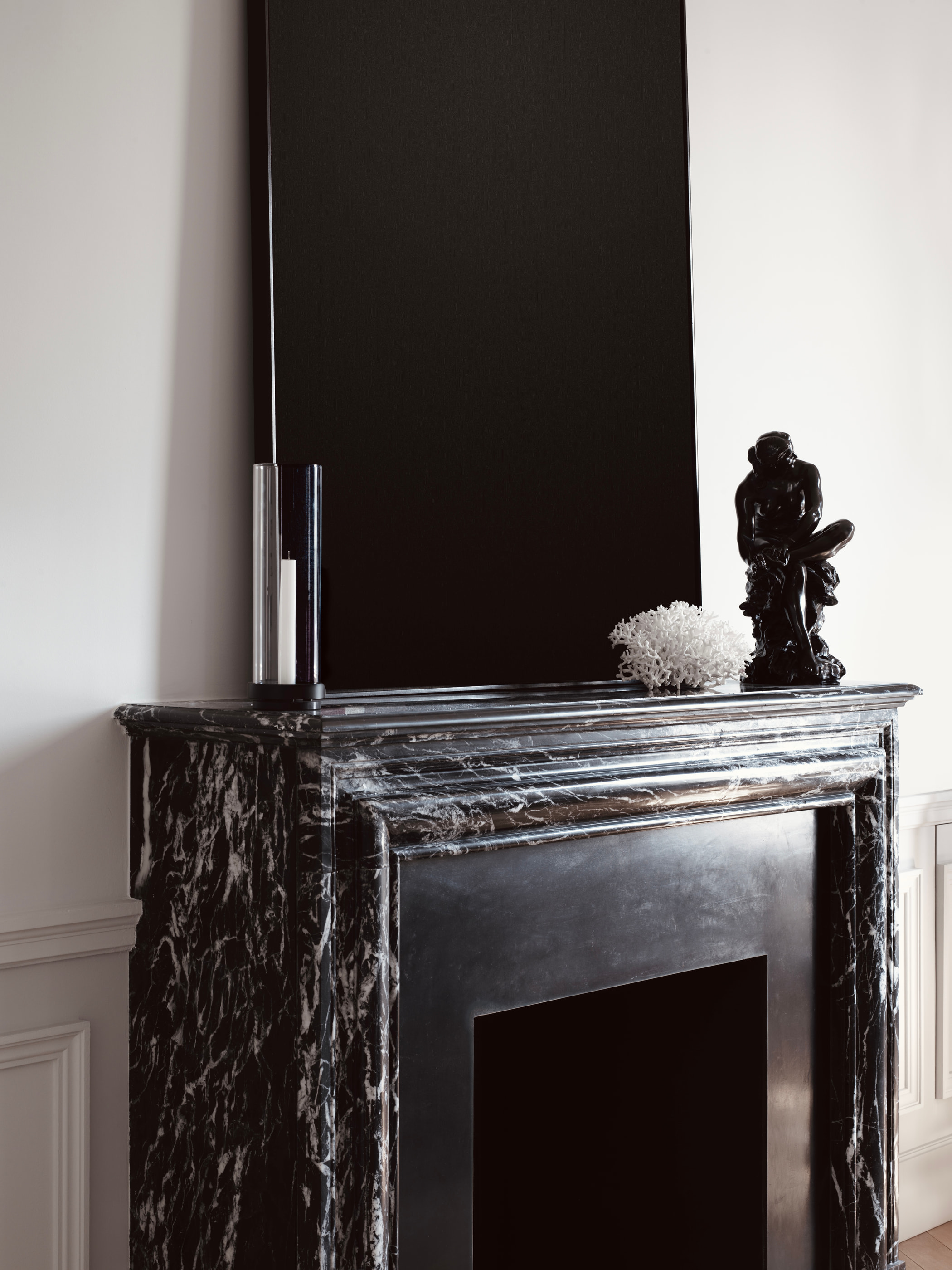 VH Penthouse by Guillaume Alan — veined black marble fireplace with sculpture and mirror, apartment in Paris